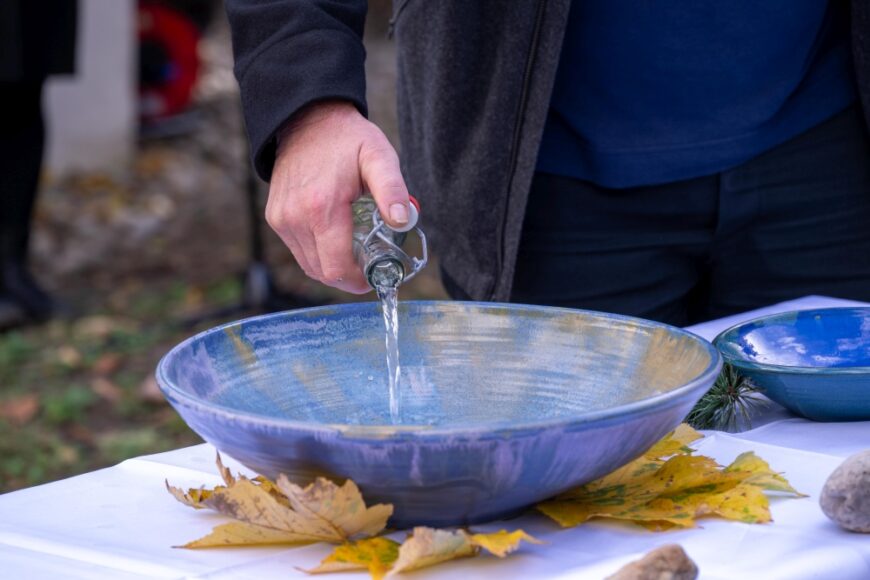 Wasser wird in eine blaue Schüssel geschütet