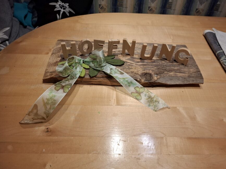 Ein Holzbrett mit Holzbuchstaben die das Wort Hoffnung darstellen